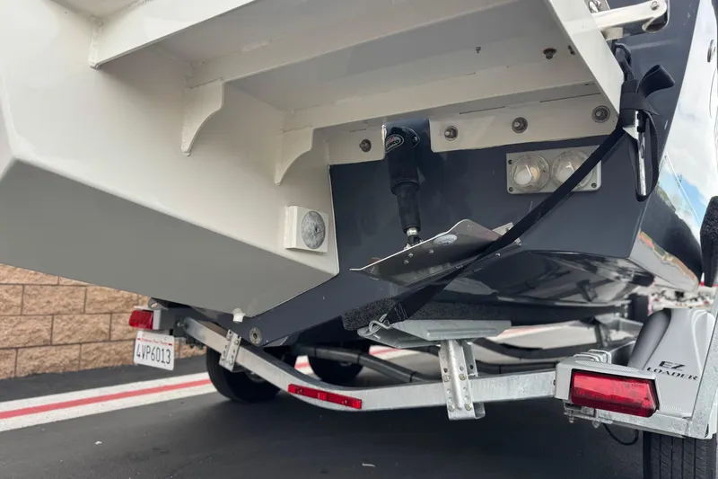 Slide: The Image of 2023 Defiance 220 Admiral EX boat on trailer, rear view showing hull and trailer details. - 10