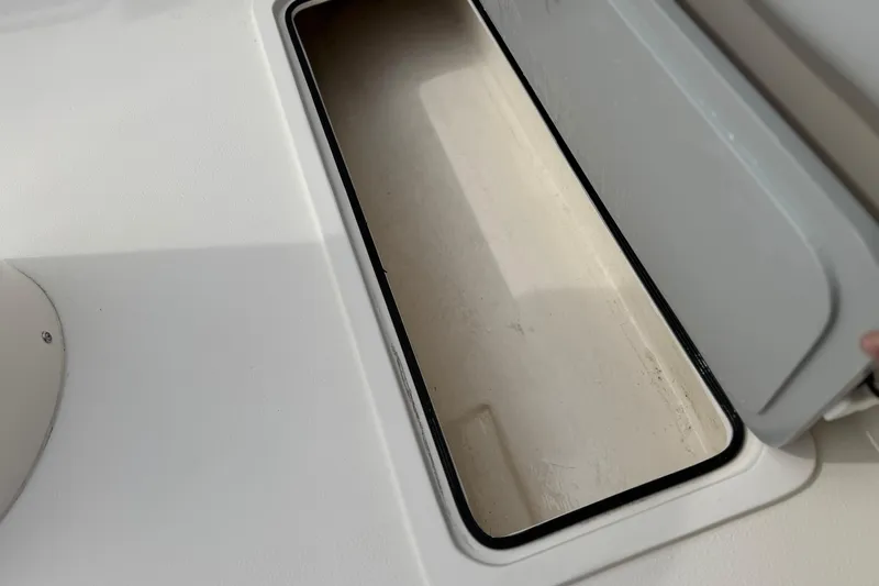 Slide: The Image of Open storage compartment on 2023 Defiance 220 Admiral EX boat. - 13