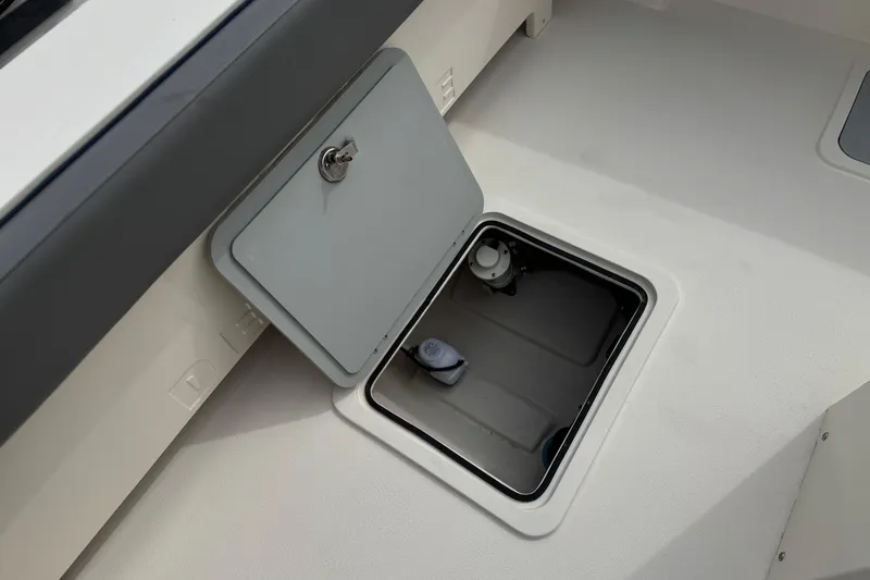 Slide: The Image of Open storage compartment on 2023 Defiance 220 Admiral EX boat deck. - 14
