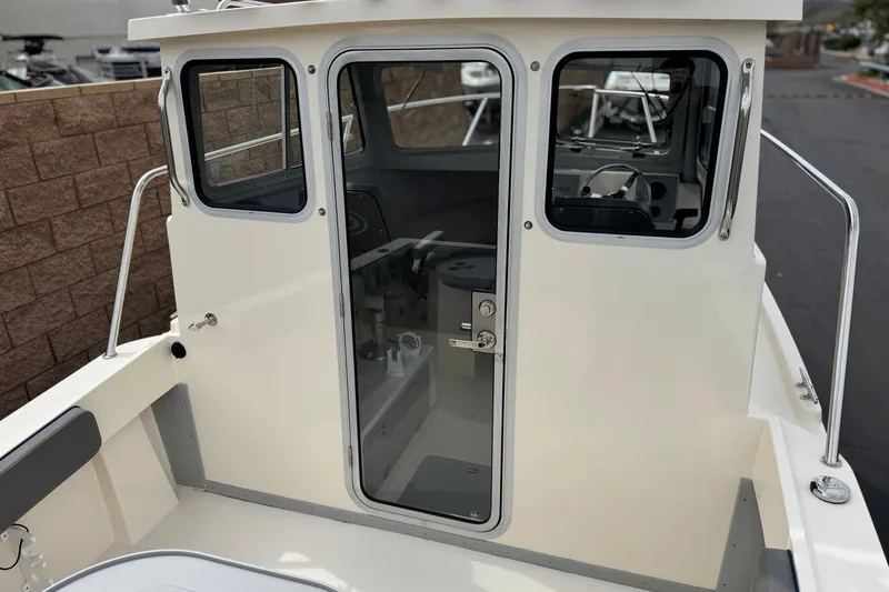 Slide: The Image of 2023 Defiance 220 Admiral EX boat cabin with glass door and windows. - 17