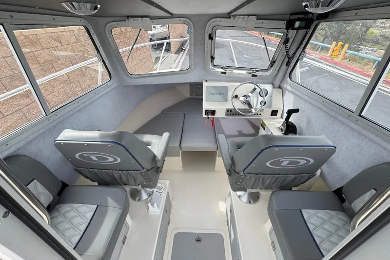 Slide: The Image of Interior of 2023 Defiance 220 Admiral EX boat with seating and navigation equipment. - 19