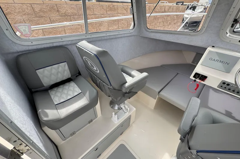 Slide: The Image of Interior of 2023 Defiance 220 Admiral EX boat with seating and Garmin navigation system. - 20