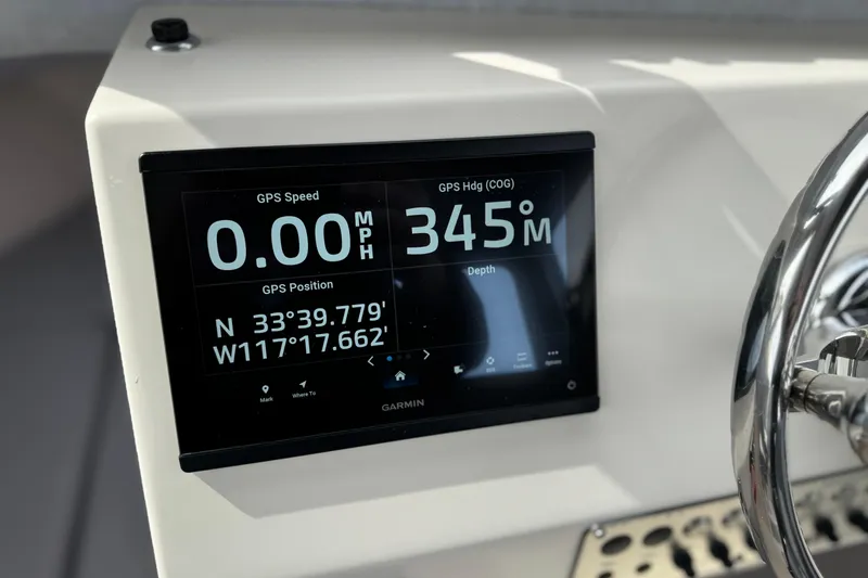 Slide: The Image of 2023 Defiance 220 Admiral EX boat dashboard with Garmin GPS display showing speed and coordinates. - 27