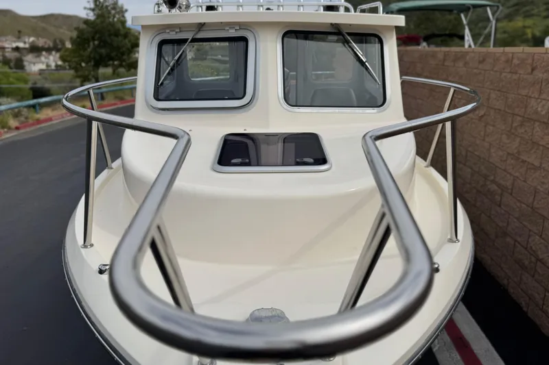 Slide: The Image of 2023 Defiance 220 Admiral EX boat, front view with railing and windows. - 3