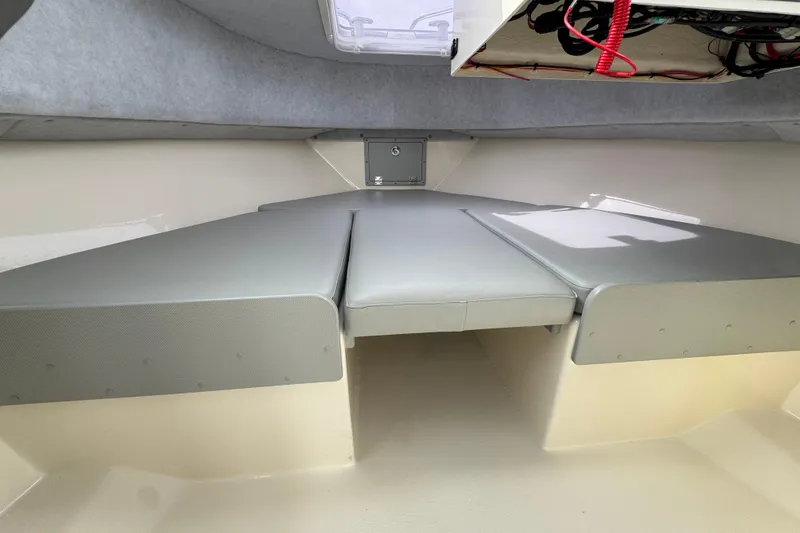 Slide: The Image of 2023 Defiance 220 Admiral EX cabin interior with cushioned seating and storage. - 34