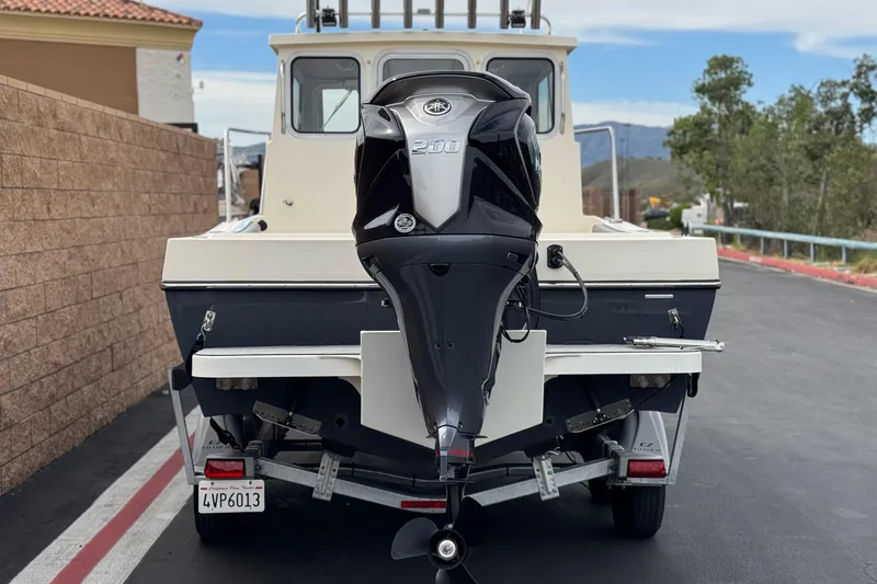 Slide: The Image of 2023 Defiance 220 Admiral EX boat with powerful outboard motor on trailer. - 6