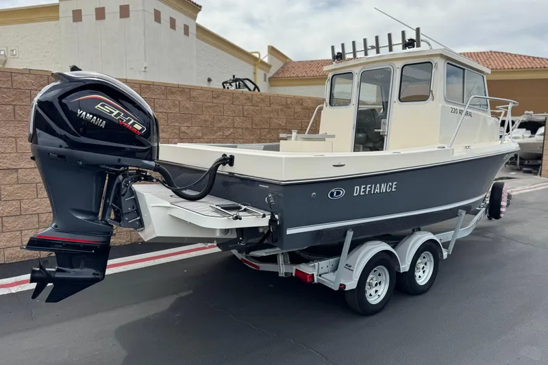 Slide: The Image of 2023 Defiance 220 Admiral EX boat with Yamaha engine on trailer. - 7