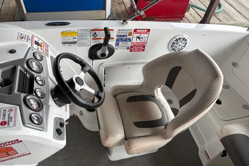 Slide: The Image of Cockpit of 2021 Tahoe 1950 boat with steering wheel and captain's chair. - 4