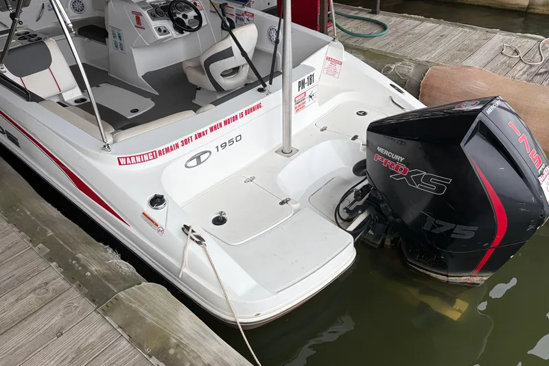 Slide: The Image of 2021 Tahoe 1950 boat with Mercury Pro XS 175 engine docked at marina. - 6