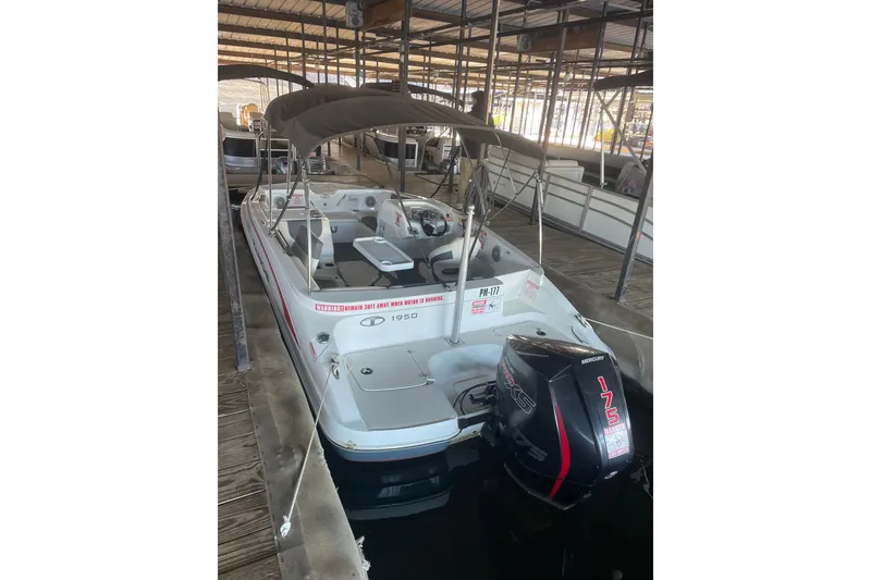 Slide: The Image of 2021 Tahoe 1950 boat with canopy and Mercury 175 engine in marina. - 3