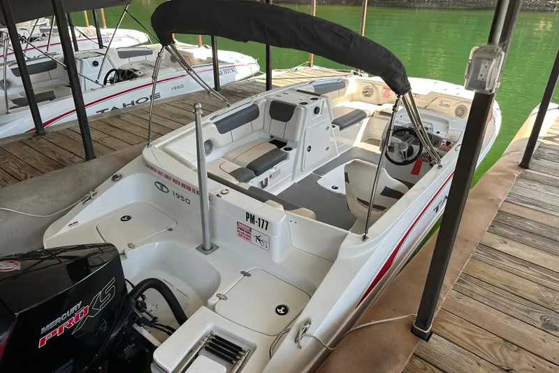 Slide: The Image of 2021 Tahoe 1950 boat docked, featuring spacious seating and Mercury Pro XS engine. - 5