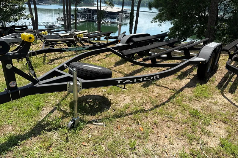 Slide: The Image of Boat trailer by Tahoe, model 1950, 2021, near a serene lakeside setting. - 7