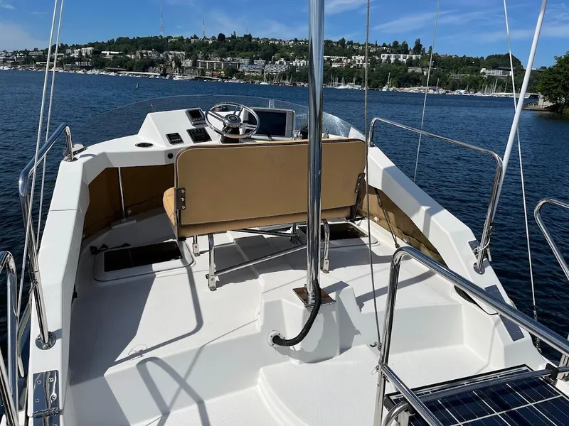 Slide: The Image of 2013 Ranger Tugs R-31 CB boat deck with helm, on a scenic lake. - 15
