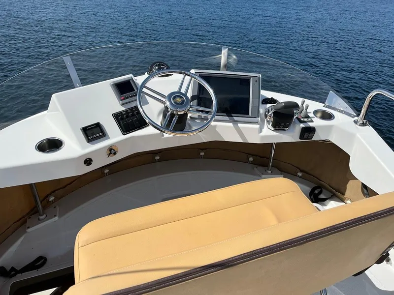 Slide: The Image of Helm of 2013 Ranger Tugs R-31 CB with steering wheel and navigation equipment. - 17