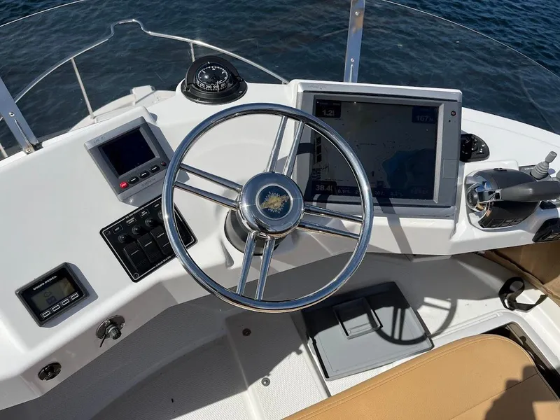 Slide: The Image of Helm of 2013 Ranger Tugs R-31 CB with navigation equipment and steering wheel. - 18