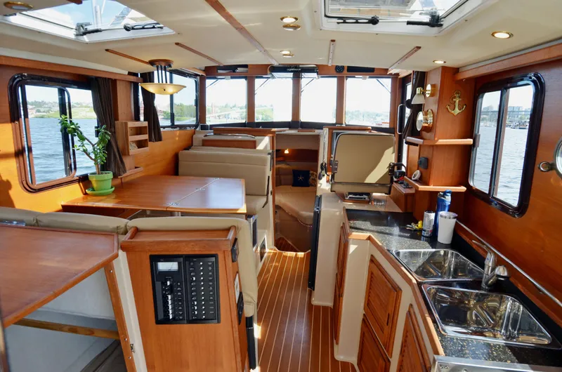 Slide: The Image of Interior of 2013 Ranger Tugs R-31 CB, featuring wood finishes and spacious layout. - 20