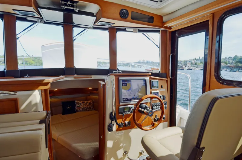 Slide: The Image of Interior of 2013 Ranger Tugs R-31 CB boat with helm, navigation equipment, and seating. - 23