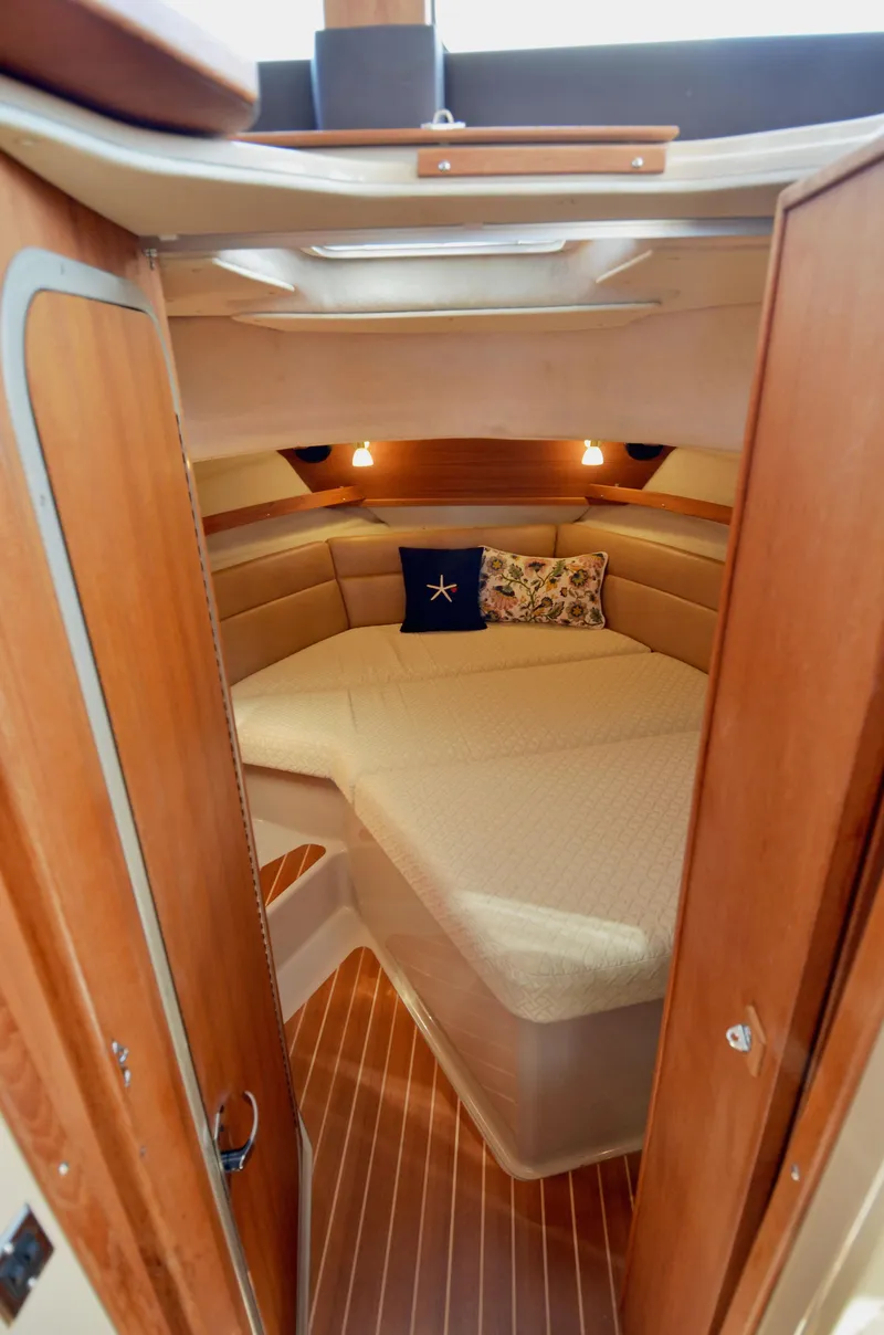 Slide: The Image of 2013 Ranger Tugs R-31 CB cabin interior with cozy bed and wooden finish. - 26