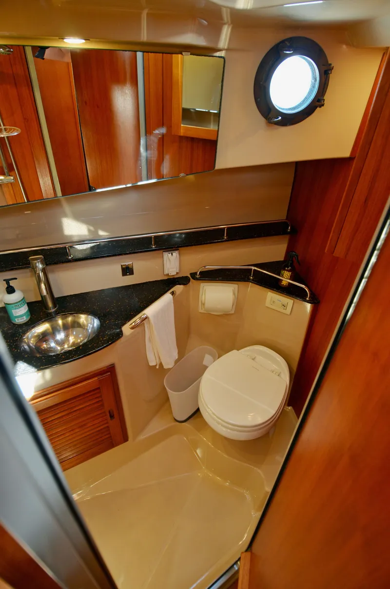 Slide: The Image of 2013 Ranger Tugs R-31 CB bathroom with modern fixtures and porthole window. - 28