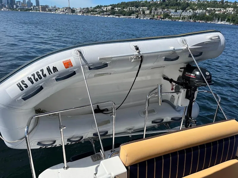 Slide: The Image of 2013 Ranger Tugs R-31 CB with mounted dinghy on calm water. - 8