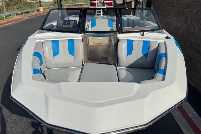 Slide: The Image of 2023 Malibu Wakesetter 21 LX boat with blue and gray interior seating. - 10