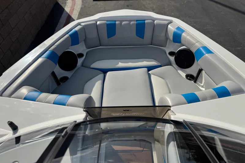 Slide: The Image of 2023 Malibu Wakesetter 21 LX boat interior with blue and white seating. - 11