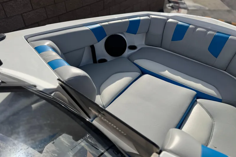 Slide: The Image of 2023 Malibu Wakesetter 21 LX boat interior with blue and gray seating. - 12