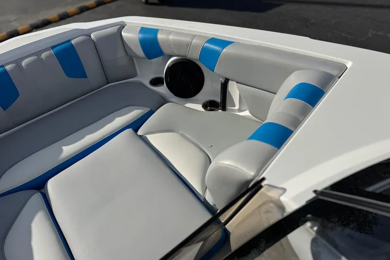 Slide: The Image of 2023 Malibu Wakesetter 21 LX boat interior with blue and white seating. - 13