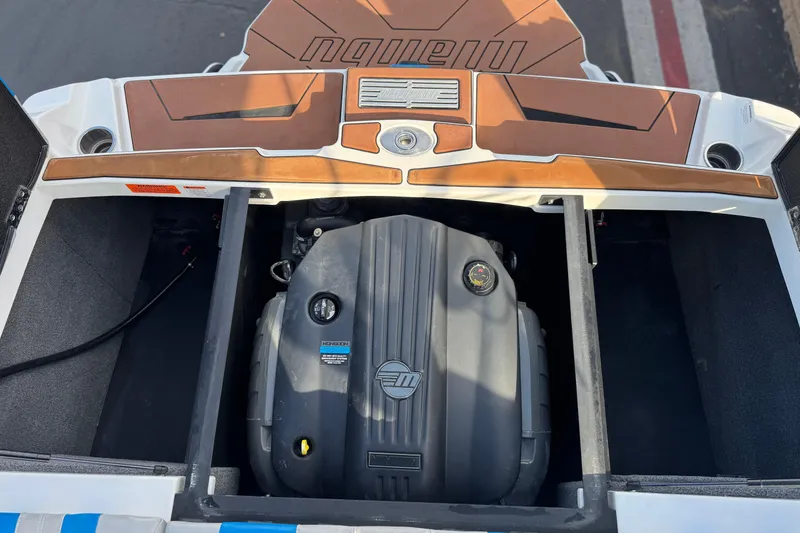 Slide: The Image of 2023 Malibu Wakesetter 21 LX engine compartment with open hatch, showcasing engine details. - 22