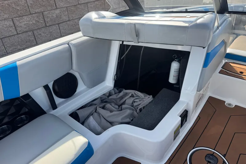 Slide: The Image of 2023 Malibu Wakesetter 21 LX interior with storage compartment and fire extinguisher. - 25