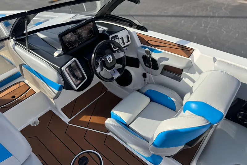 Slide: The Image of 2023 Malibu Wakesetter 21 LX interior with modern dashboard and blue-accented seating. - 28
