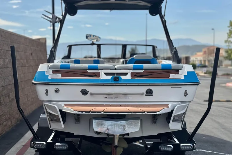 Slide: The Image of 2023 Malibu Wakesetter 21 LX boat, rear view, parked on trailer. - 4