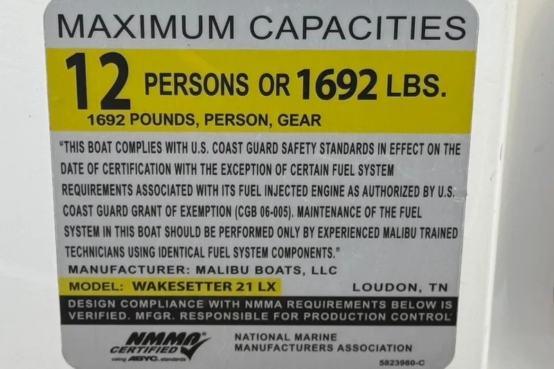 Slide: The Image of 2023 Malibu Wakesetter 21 LX capacity label: 12 persons or 1692 lbs, U.S. Coast Guard compliant. - 40