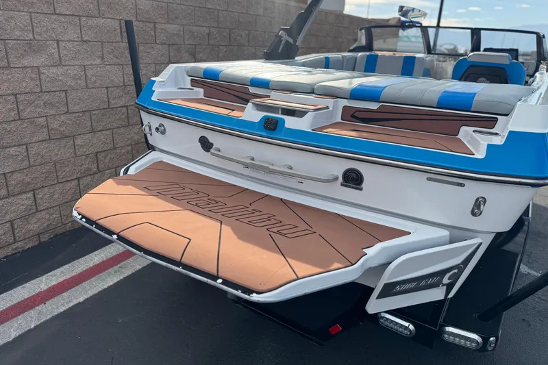 Slide: The Image of 2023 Malibu Wakesetter 21 LX boat, rear view with swim platform and seating. - 6