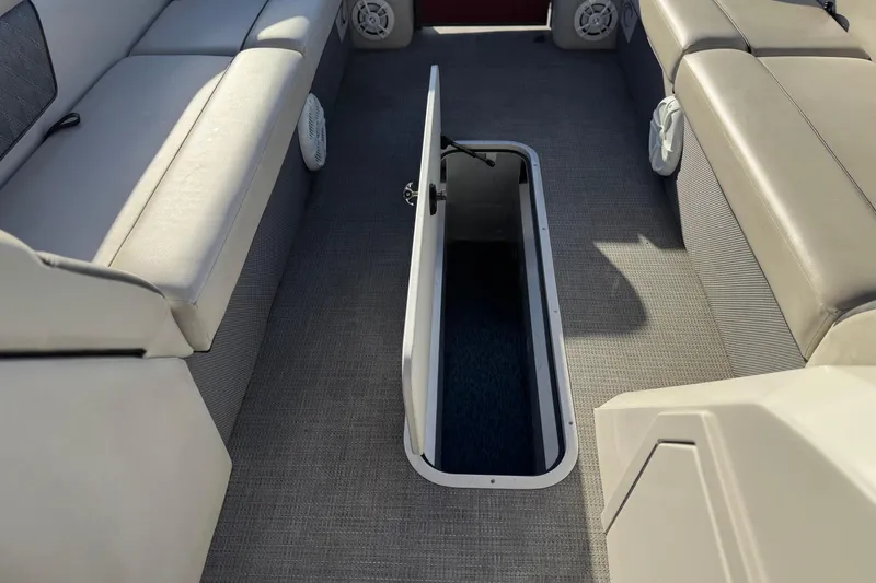 Slide: The Image of 2021 Crest Classic DLX 240 SLC boat interior with open storage compartment. - 13