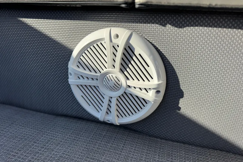 Slide: The Image of White speaker on gray upholstery of 2021 Crest Classic DLX 240 SLC boat. - 14
