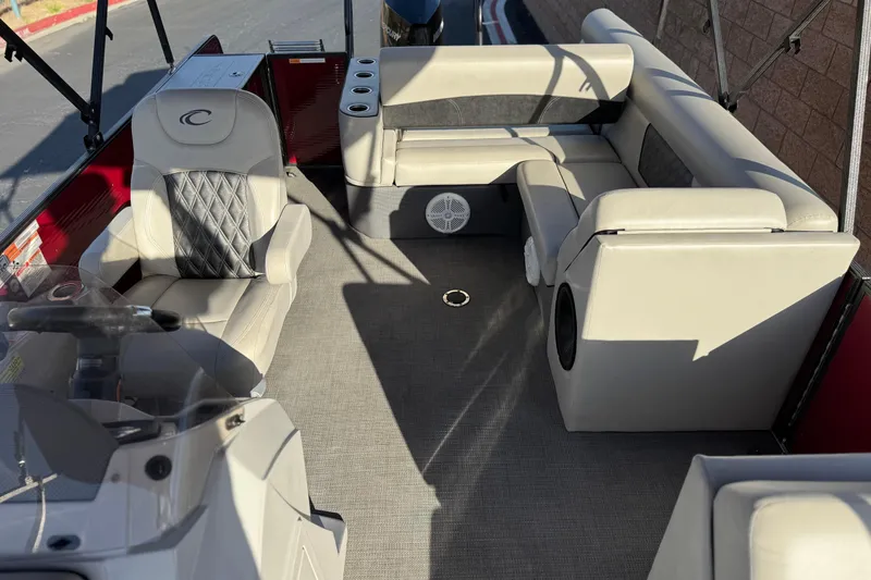 Slide: The Image of 2021 Crest Classic DLX 240 SLC boat interior with plush seating and modern design. - 18