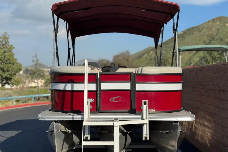Slide: The Image of 2021 Crest Classic DLX 240 SLC pontoon boat with red exterior and canopy. - 2