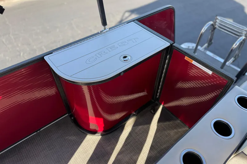 Slide: The Image of 2021 Crest Classic DLX 240 SLC boat interior with red panels and storage compartment. - 24