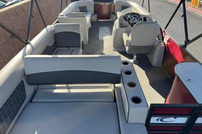 Slide: The Image of 2021 Crest Classic DLX 240 SLC pontoon boat interior with seating and steering console. - 27