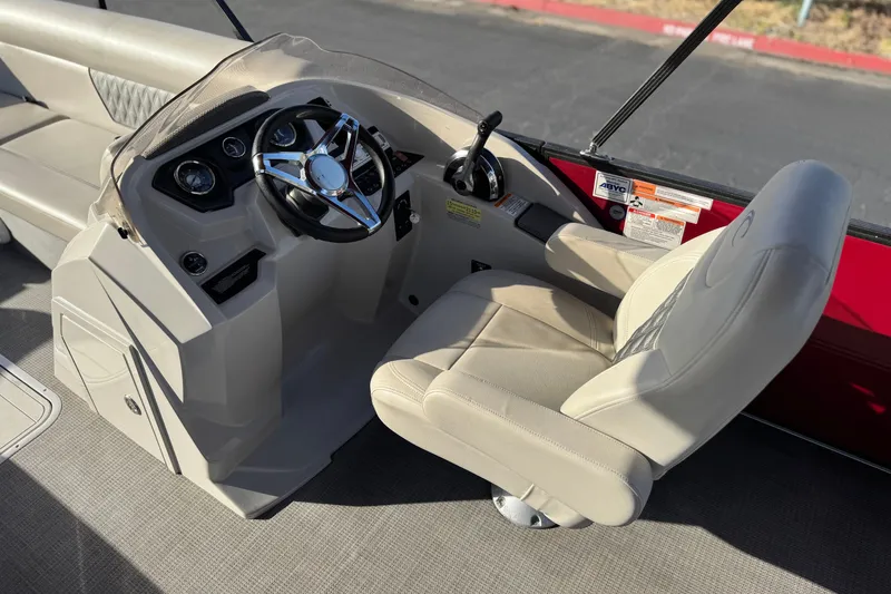 Slide: The Image of 2021 Crest Classic DLX 240 SLC boat helm with steering wheel and captain's chair. - 28