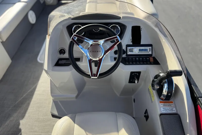 Slide: The Image of Steering console of 2021 Crest Classic DLX 240 SLC boat with controls and dashboard. - 29