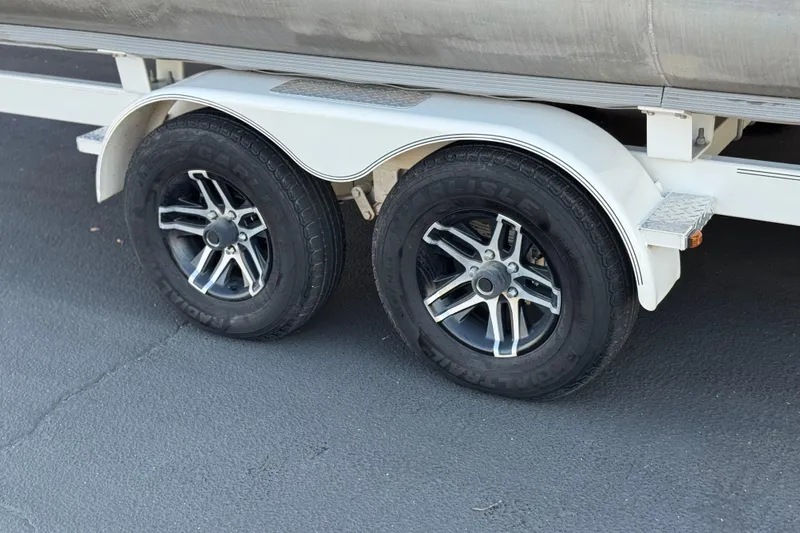 Slide: The Image of Trailer wheels of 2021 Crest Classic DLX 240 SLC on asphalt surface. - 33