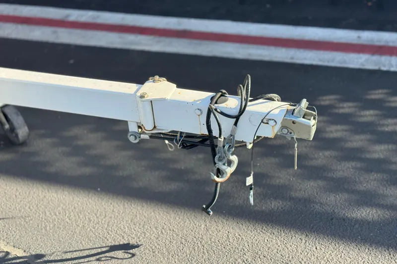 Slide: The Image of Trailer hitch of a 2021 Crest Classic DLX 240 SLC on asphalt surface. - 34