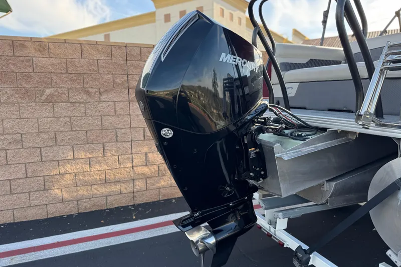 Slide: The Image of 2021 Crest Classic DLX 240 SLC with Mercury outboard motor, parked on a trailer. - 7