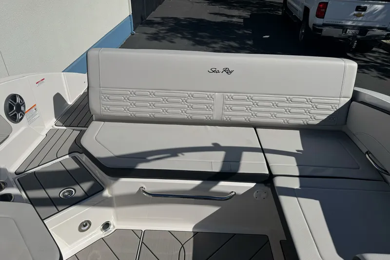 Slide: The Image of 2026 Sea Ray SPX 210 boat interior with cushioned seating and sleek design. - 9