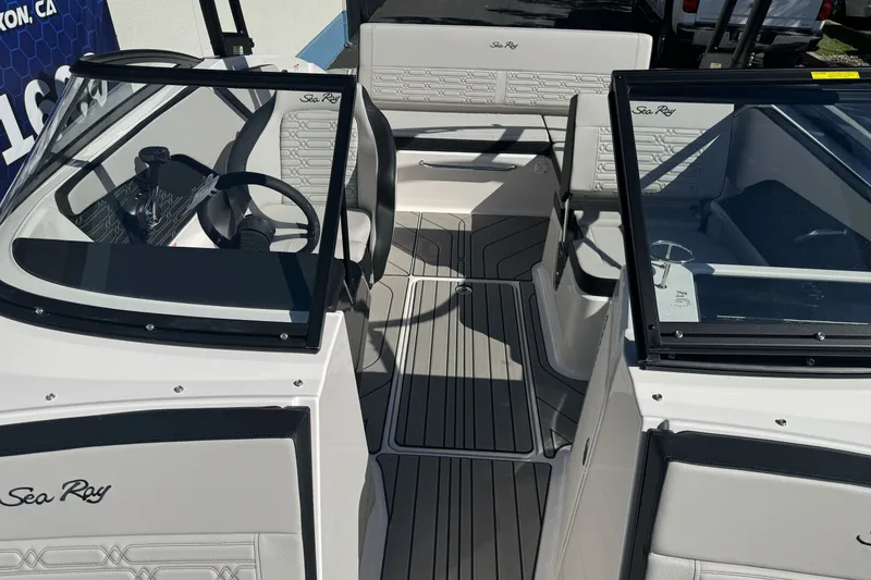 Slide: The Image of 2026 Sea Ray SPX 210 boat interior with sleek seating and modern dashboard design. - 19