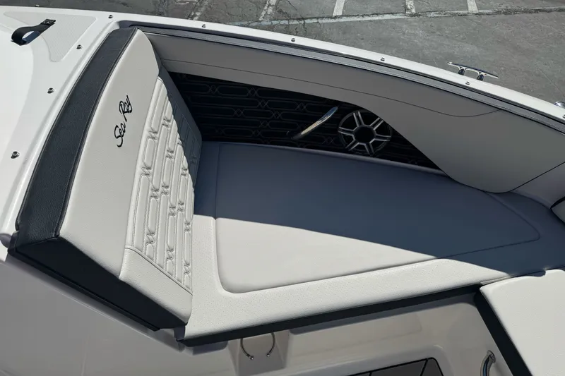 Slide: The Image of 2026 Sea Ray SPX 210 boat interior with cushioned seating and speaker detail. - 16