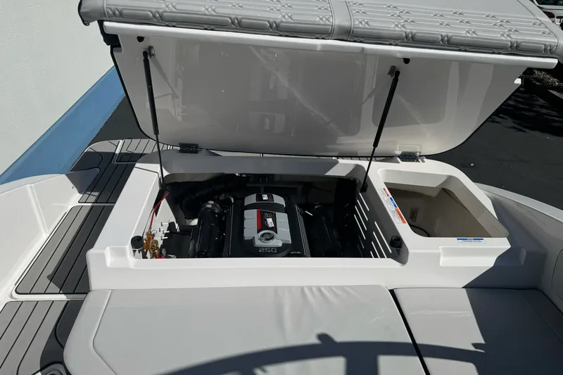 Slide: The Image of 2026 Sea Ray SPX 210 boat engine compartment with open hatch, showcasing engine details. - 26