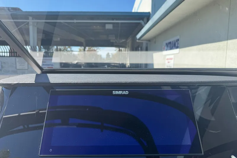 Slide: The Image of Simrad display on 2026 Sea Ray SPX 210 boat dashboard, outdoor setting. - 13